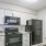 Kitchen with white cabinets and black appliances