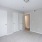 Carpeted room with three closet doors